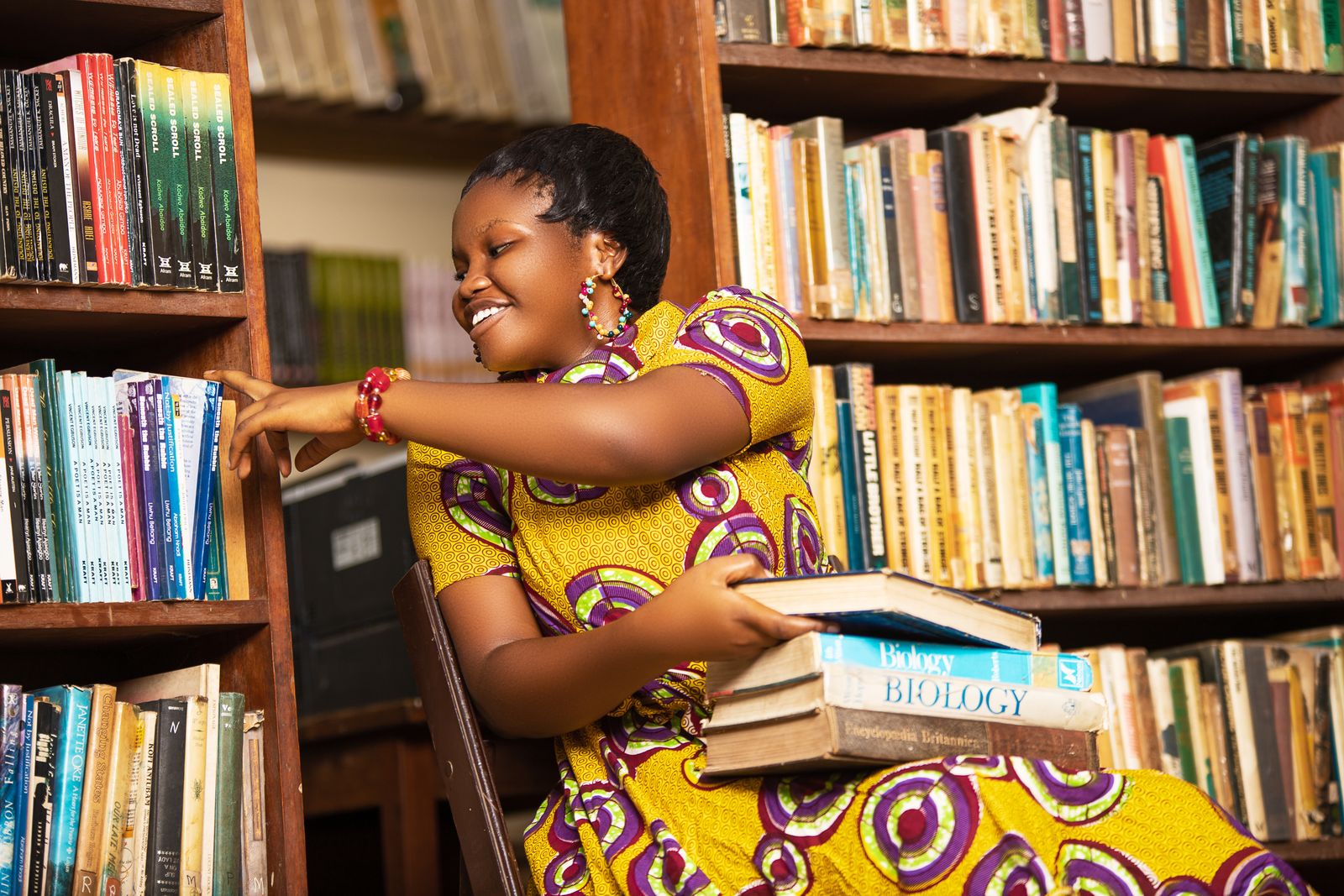 Student reading in a library in Ghana
